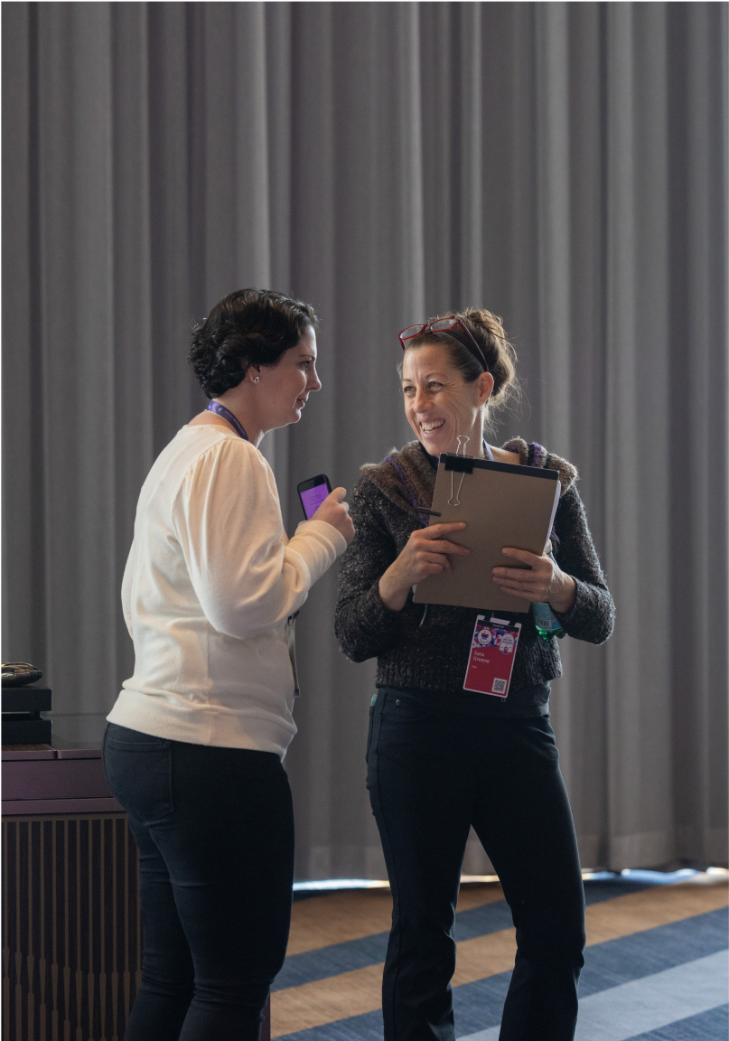 Two women speaking at an event