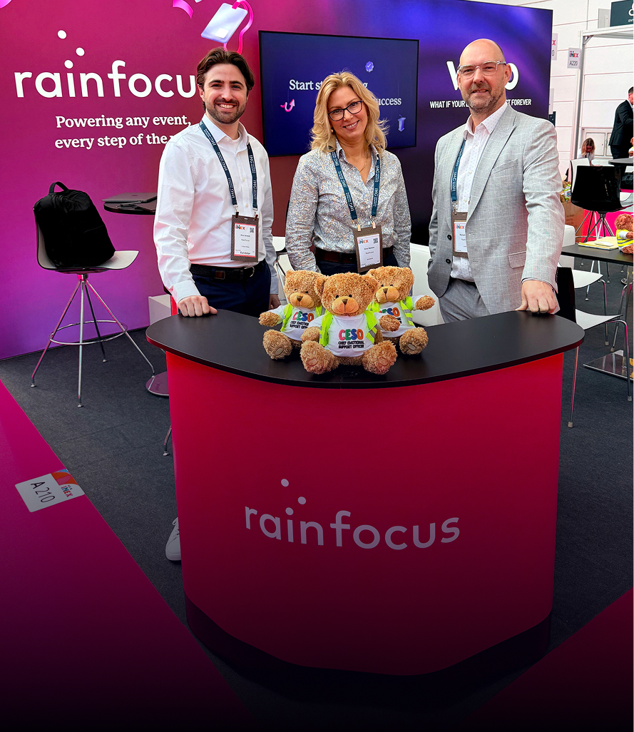 RainFocus team members at trade show booth with branded teddy bear mascots