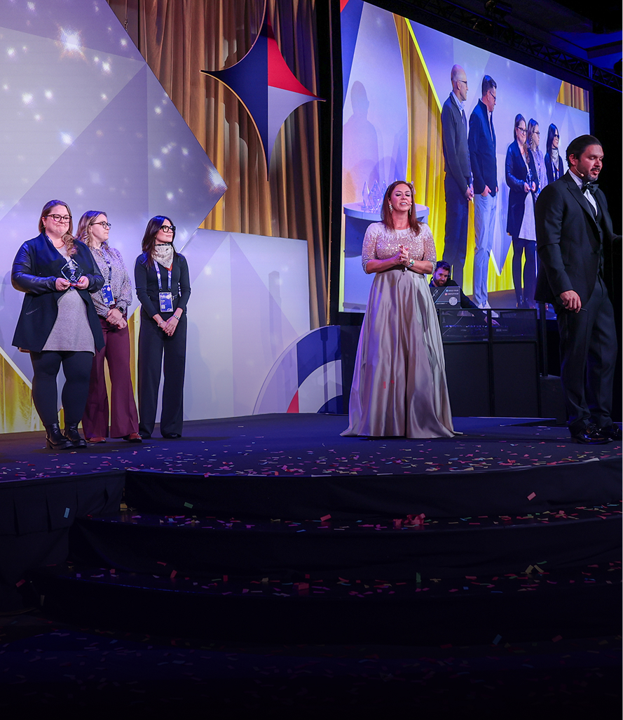 Awards ceremony on main stage with confetti and formal attire