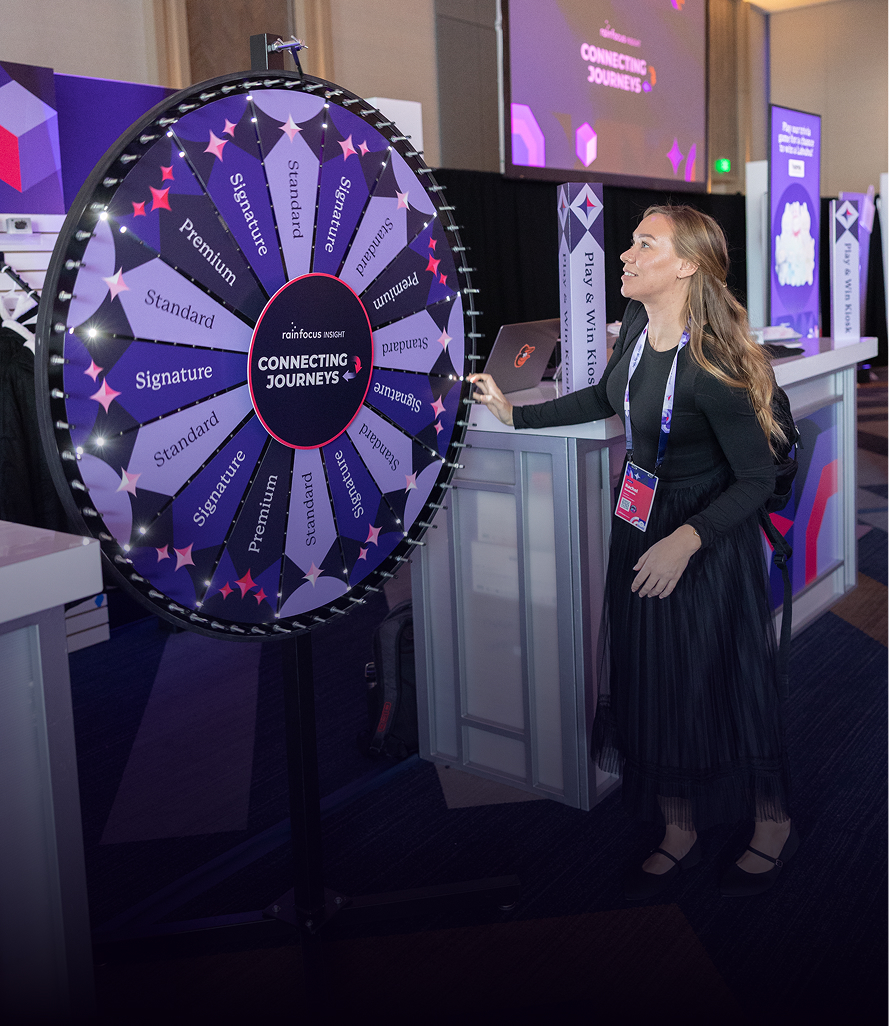 Attendee spinning prize wheel at interactive booth experience